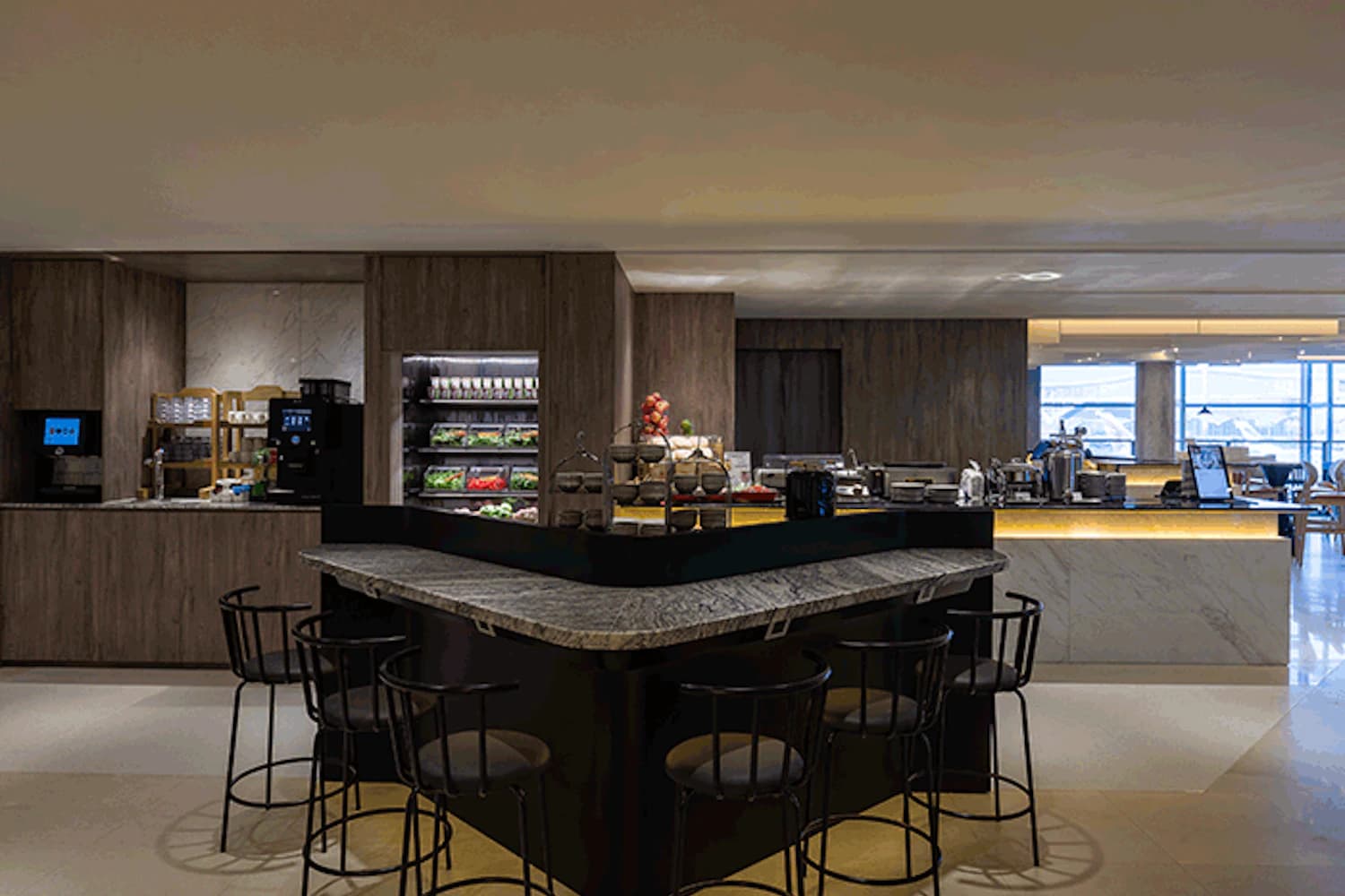 Bar mit hohen Hockern, Snacktheke und Kaffeemaschinen in der Plaza Premium Lounge Gate 60 am Flughafen Hongkong